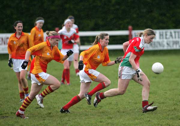 Cora Staunton Carnacon is pursued by Clare O'Hara and Ann Nolan Castlebar Mitchels in the final of the Aisling McGing Tournament in Clogher. Photo Michael Donnelly