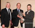 Sean Kelly President GAA makes a presentation of a Waterford Crystal lamp on behalf of the Club to Tommy Lyons manager Ballina Stephenites at the Ballina Stephenites All Ireland Senior Club champions 2005 Victory Celebration Dinner in the Downhill House Hotel, Ballina Included in photo on left is Padraig Prendergast Club chairman. Photo Michael Donnelly