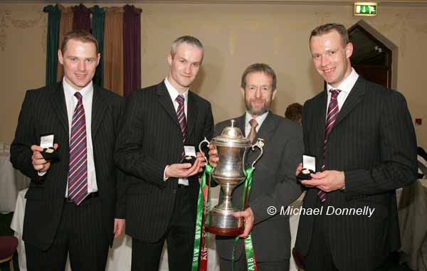 The Brady Brothers display their All Ireland  Senior Football Club Medals as Sean Kelly president GAA holds the Andy Merrigan Cup at the Ballina Stephenites Victory Celebration dinner in The Downhill House Hotel, Ballina, from left: Ger, Liam and David Brady. Photo Michael Donnelly